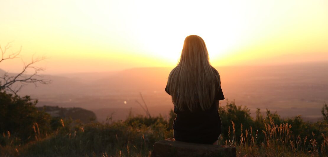 woman looking at sunset